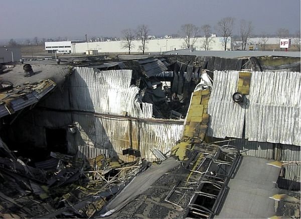 Widok zarwanego dachu ocieplonego wełną mineralną stanowiącego pokrycie hali w Gliwicach; skutki pożaru w 2003 roku